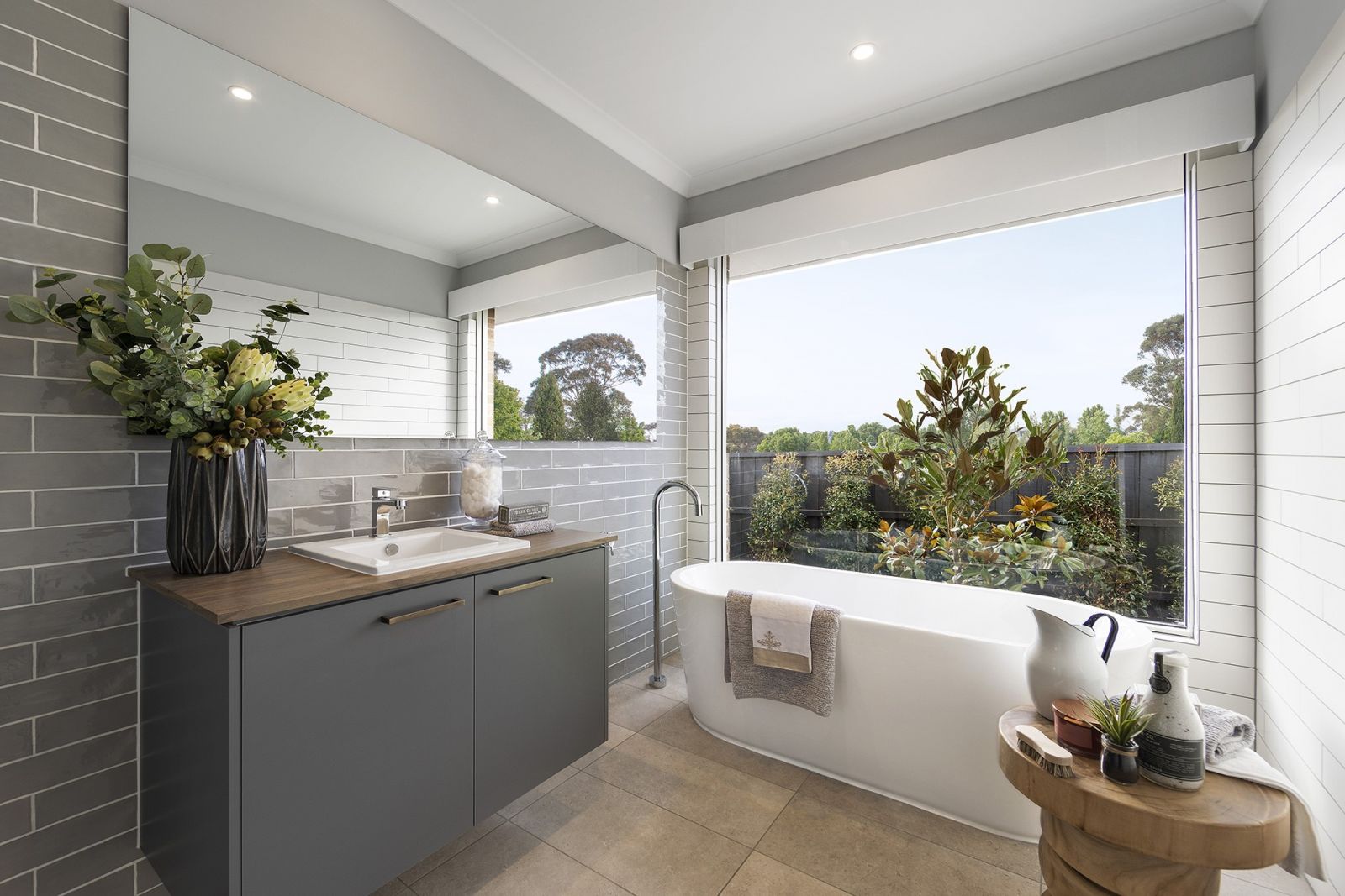 modern country style bathroom with grey gloss subway tiles and freestanding bath